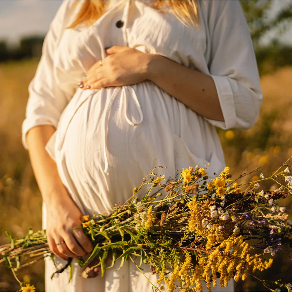 Couple holding hands with a blooming spring background, symbolizing new beginnings and fertility planning in February.